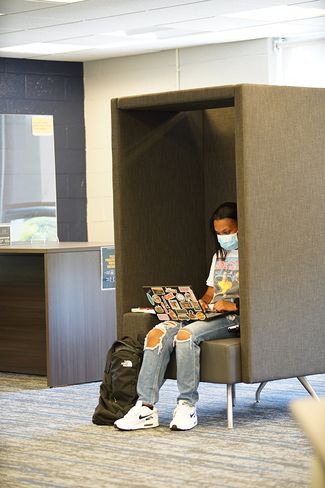 A student utilizes one of the library’s new study pods that just happens to also promote physical distancing