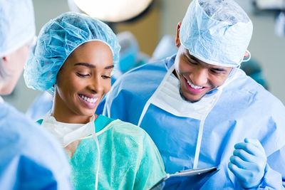 A surgical technician assisting a doctor in the OR