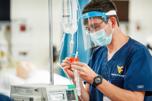 WVU PSC Nursing Student Benjamin Ritz, a junior in the program, is shown setting an IV infusion.  