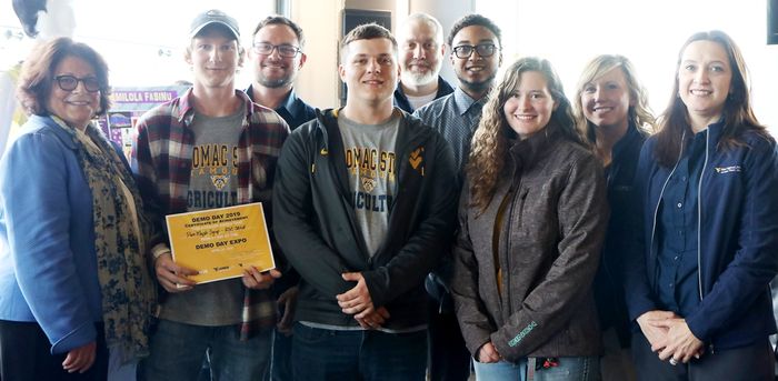 WVU Provost Joyce McConnell presenting the award; SAGE Student Kyle Cessna; SAGE Director Corey Armstrong, SAGE Student Kyle Creamer, Multi-Media Specialist David Miller, SAGE Students Dylan Mapp and Hannah Dickson and Business Instructor Amy Weaver, and 