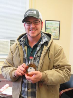 Jacob Riggleman, a horticulture major from Buchannan, W.Va., displays a bottle of the maple syrup he helped tap, cook, and bottle at West Virginia University Potomac State College.  The maple syrup is currently for sale by calling 304.257.8131.