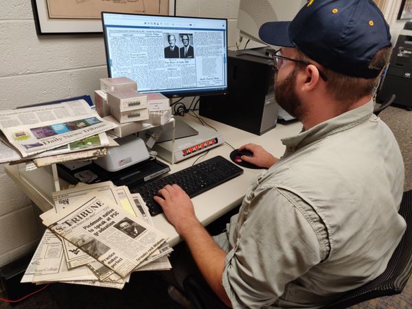 Nick Gardner, interim program coordinator for the WVU Potomac State College library, demonstrates how easily accessible some local newspapers are now that these have been digitized. 