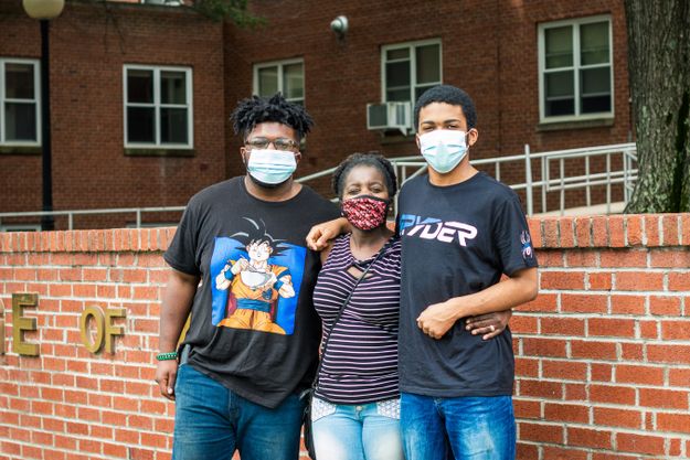 Freshman Lamont Lee, far left, on move-in day with his mom and younger brother