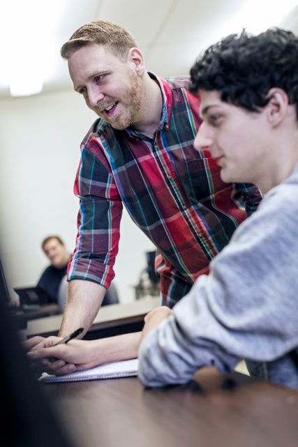 A student being instructed on how to use their computer.
