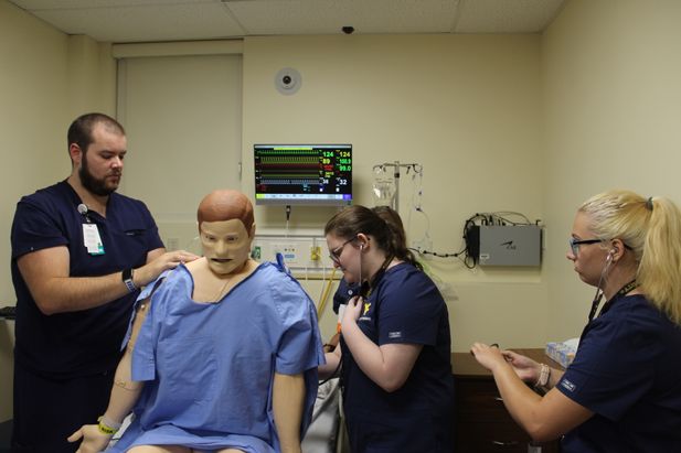 Jason Liller, PVH ED Manager, works with participants Samantha Knotts and Emmaleigh Bittinger in a simulation related to congestive heart failure.